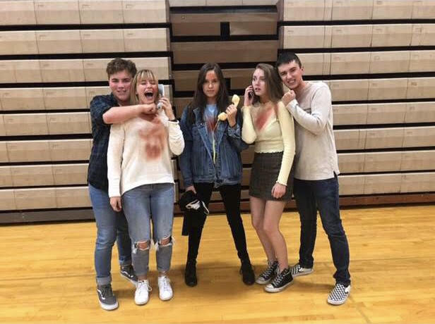 Five seniors dressed up from popular movie series Scream