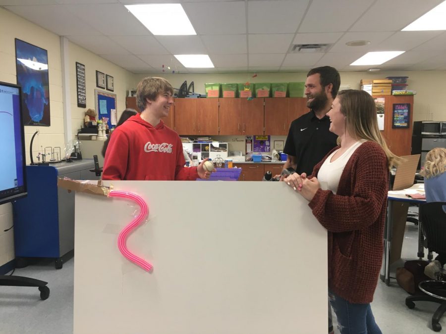 Students discuss their current project with Mr. Abrams; Rube Goldberg machines.