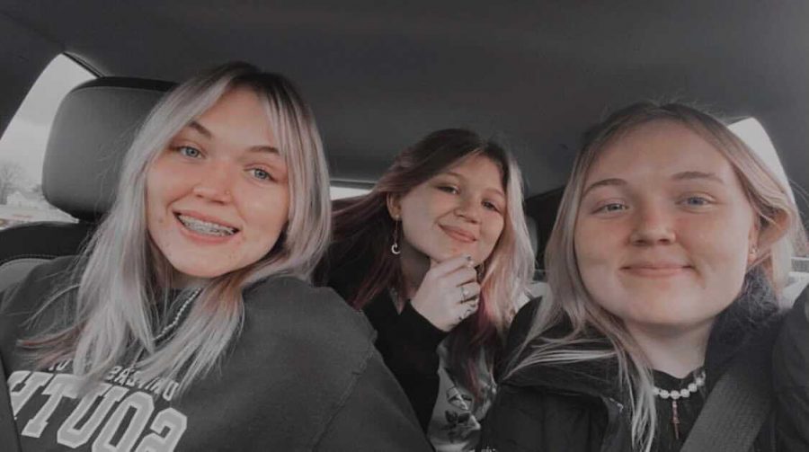 3 sisters share a little moment. From left to right: Emma Rankin, Logan Rankin, and Lainey Rankin