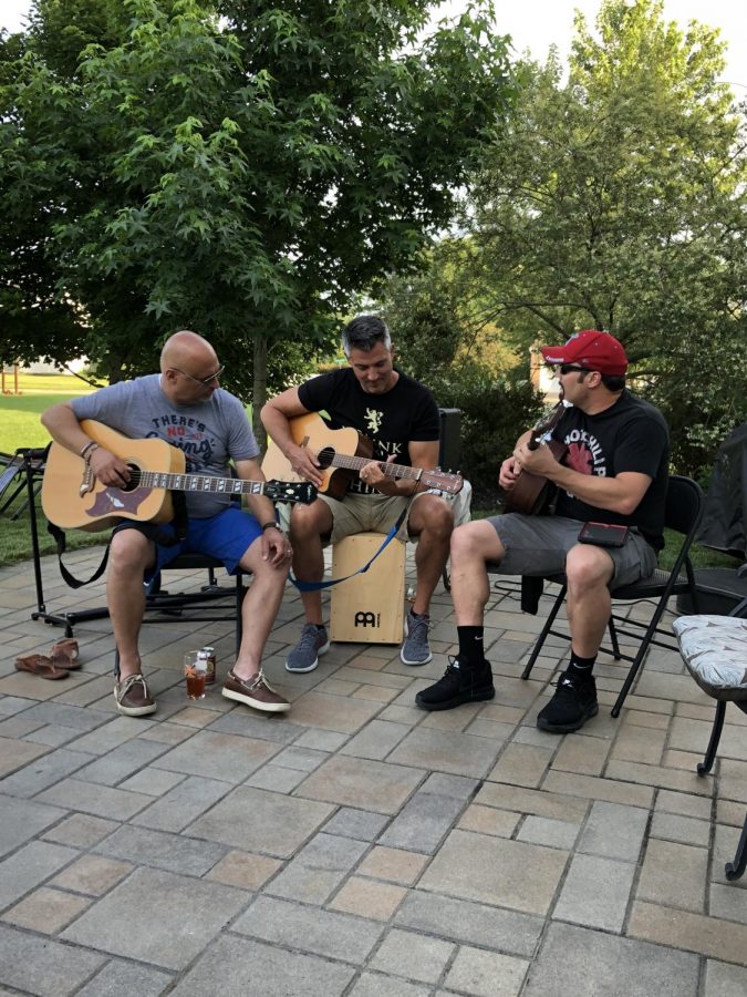 Mr. Gonzalez, Mr. Moore, and Mr. Hicks playing guitar