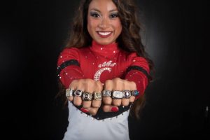 Coach Courtney Dang wearing all her national title rings.

