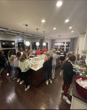 Cheerleaders eating thanksgiving food together 