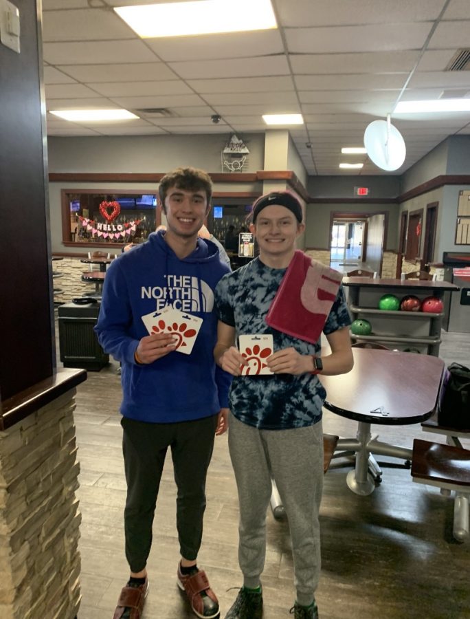 Tony Milazzo and Chase Adams hold up their gift cards awarded for performing well