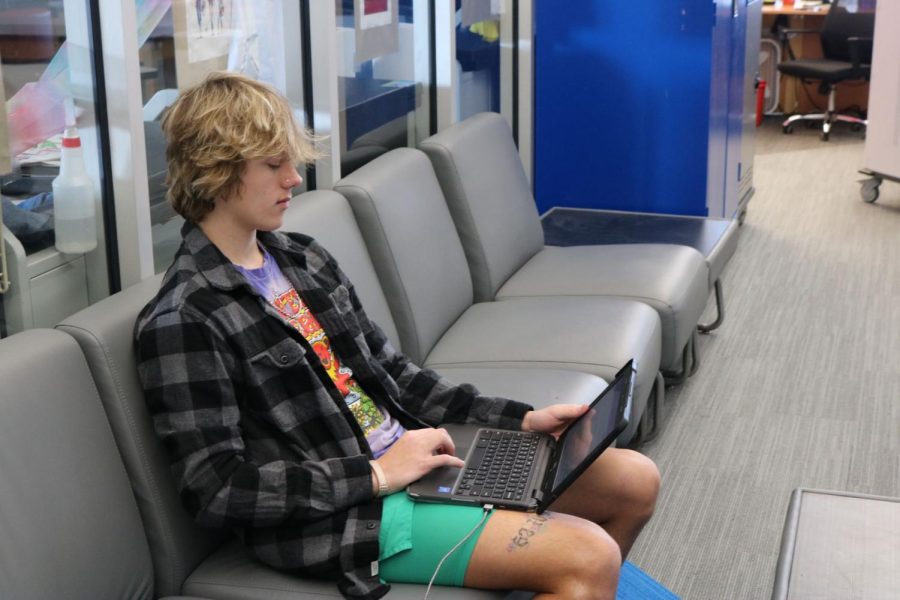 Dane Drake, sophomore,  watches youtube while he waits for yearbook class to start