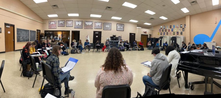 Students cast in the Wizard Of Oz sit in a large circle for their first script read-through