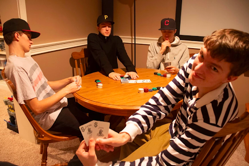 Grant plays poker with his different personas from left to right; Grant, GRen, GWiz, and G.