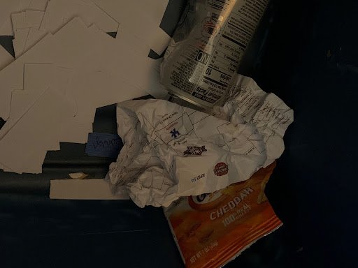 Crumbled up and busted March Madness bracket thrown in the trash