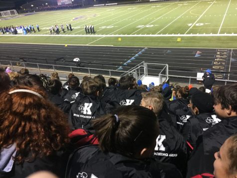 Students wait in anticipation while they watch the drum majors line up on the front sideline in preparation for awards to be announced.