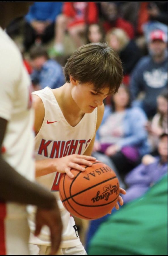 Talan Noyes dripples the basketball during his game getting ready to make a basket.
