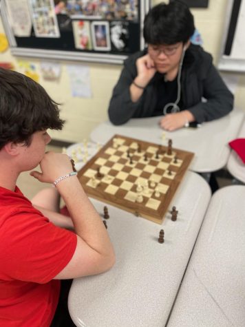 Pupil Kid Thinking About His Next Move In A Game Of Chess. Clever  Concentrated And Thinking Child While Playing Chess. Little Clever Boy  Thinking About Chess. Games Good For Brain Intelligence. Stock