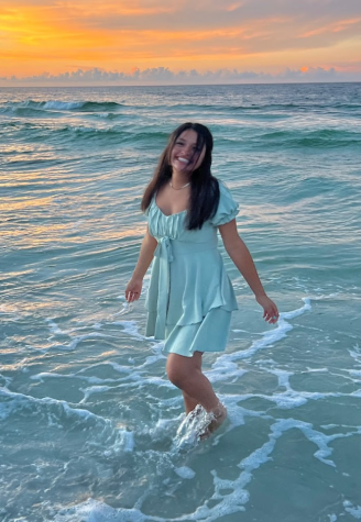 Claudia Fay smiles in the waves of the ocean in Panama City beach, Florida (Photo Credit: Hannah Fay) 