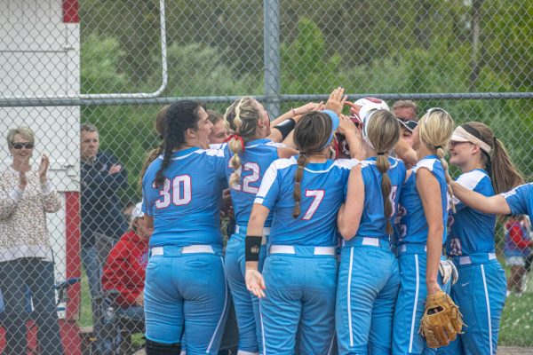 The softball team celebrates together after a home run against Little Miami -- Photo Credit: TJ Hoolehan
